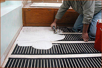 Thinset being spread over the low-voltage FloorHeat STEP element.